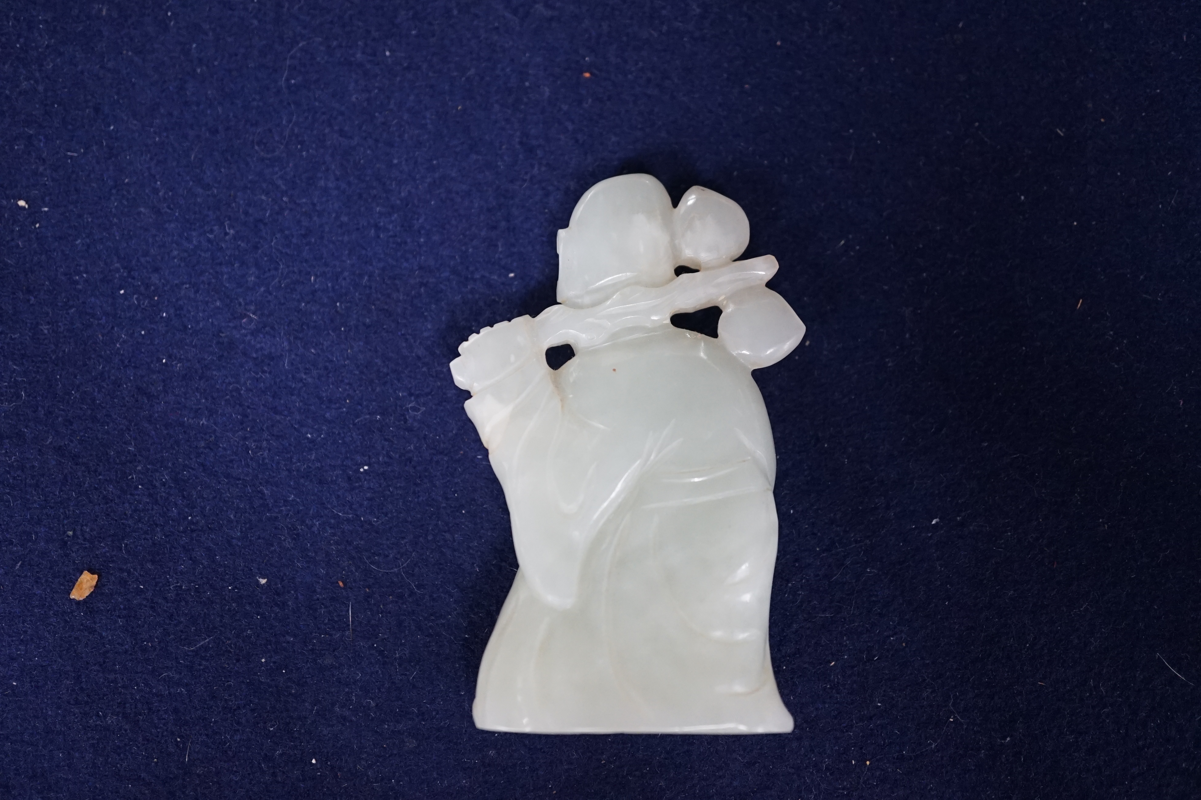 A Chinese pale celadon jade figure of Shou Lao, wood stand, 10cm high